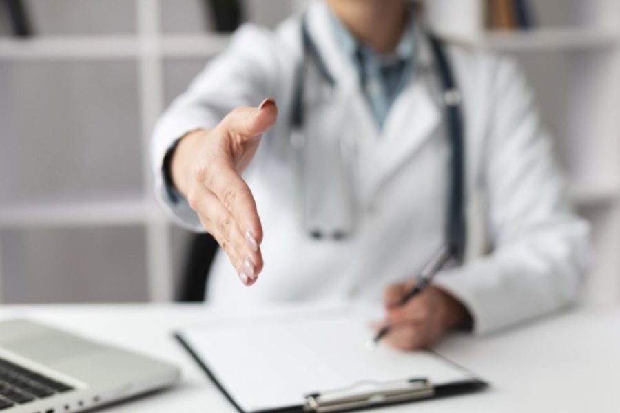 close-up-doctor-waiting-shake-patients-hand-scaled-e1648730053973